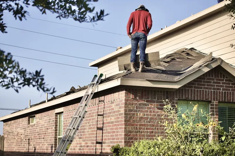 Professional roofer working on a residential roof in Vallecito